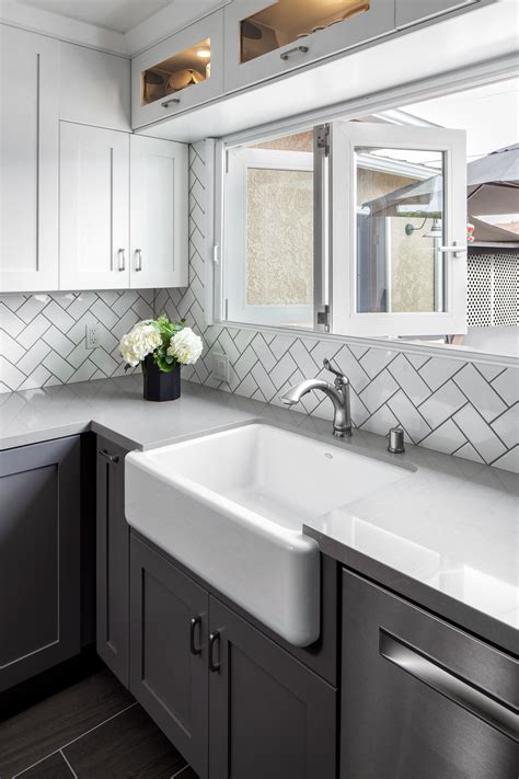 remodeled kitchen complete with white subway tile backsplash in herringbone pattern … white