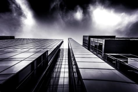 An Office Building With A Glass Facade Shrouded In Fog Office Building