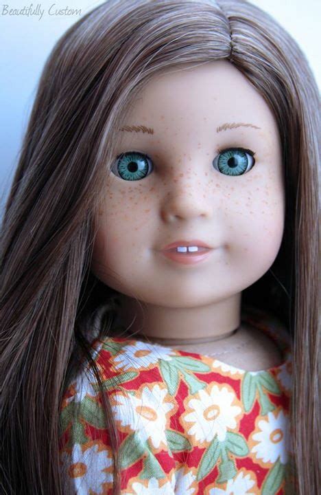 A Close Up Of A Doll With Long Brown Hair And Blue Eyes Wearing A Dress