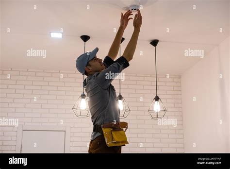 Handyman Installing A Smoke Detector On The Ceiling Stock Photo Alamy