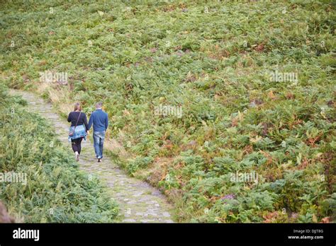 Couple Walking Near The Bridestones In The Dalby Forest In The North
