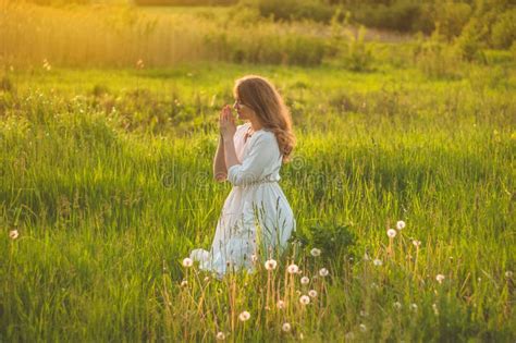 Girl Closed Her Eyes Praying In A Field During Beautiful Sunset Hands