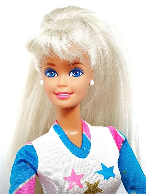A Barbie Doll With Blonde Hair And Blue Eyes Wearing A White Sweater