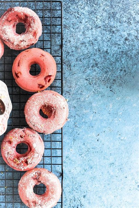 Several Pink Donuts Sitting On A Cooling Rack