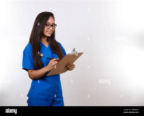 An Attractive Latina Nurse Calls Her Next Patient Stock Photo Alamy