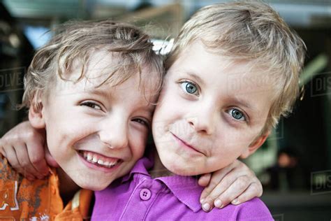 Portrait Of A Two Playful Brothers With Arms Around Stock Photo