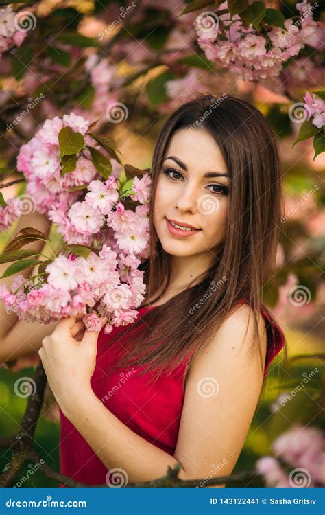 portrait of beutiful girl in sakura tree sakura flowers surround the girl sakura branch by her