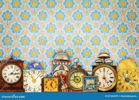 Colorful Vintage Clocks In Front Of Retro Wallpaper Stock Image Image