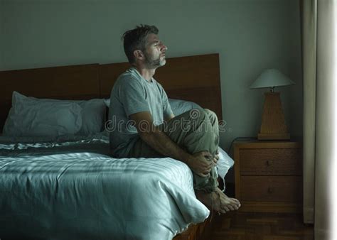 Dramatic Lifestyle Portrait Of Handsome Guy Sitting On Bed Feeli Stock Image Image Of