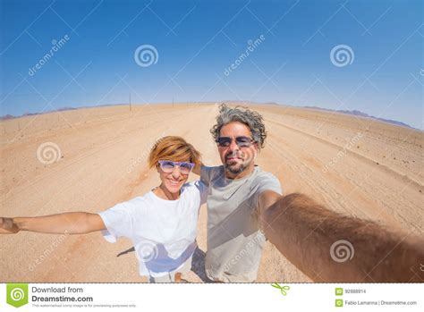 Adult Couple Taking Selfie On Gravel Road In The Namib Desert Namib