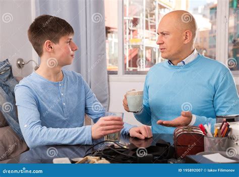father and son enjoying conversation stock image image of interior discussion 195892007