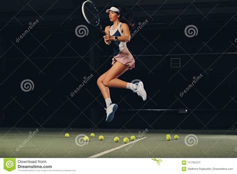 Female Tennis Player In A Jump On A Tennis Court Stock Image Image