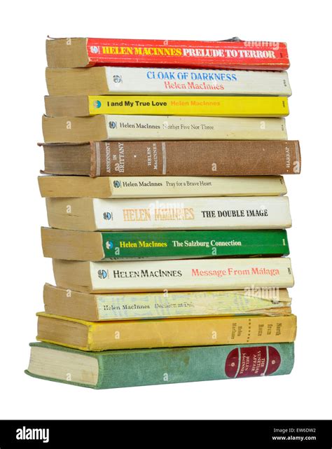 Stack Of Old Paperback Books By Author Helen Macinnes On A White