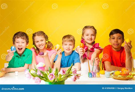 Funny Kids Holding Coloured Easter Eggs At Table Stock Photo Image Of