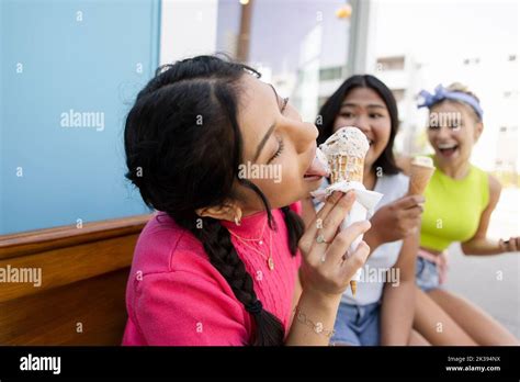 Close Up Of Girl Licking Ice Cream Cone On Wooden Bench Stock Photo Alamy