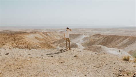 Man Standing At The Desert During Day Photo Free Masada Image On Unsplash