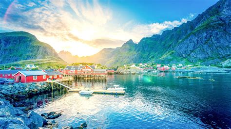 Beautiful Houses On Top Of Water With Sunbeam Mountains In Lofoten