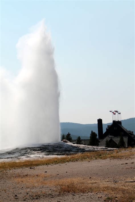 Old Faithful Geyser With Old Faithful Lodge Photo By Jezewski