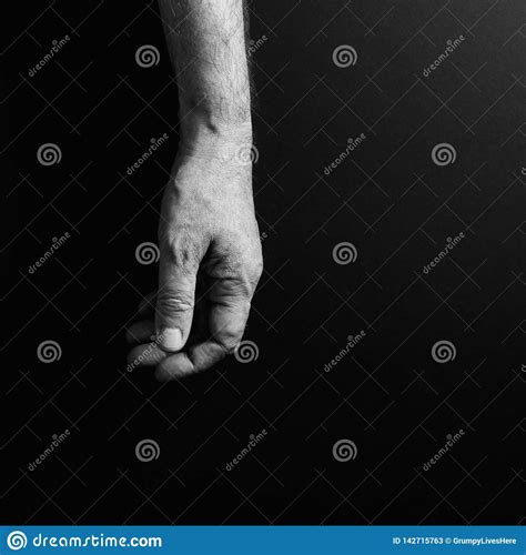 Black And White Image Of Man`s Hand Hanging Loosely Isolated Against A