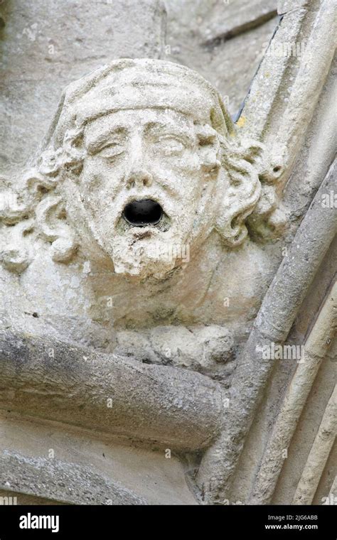 Stone Carved Gargoyle A Grotesque Water Spout Head On The Guttering Of