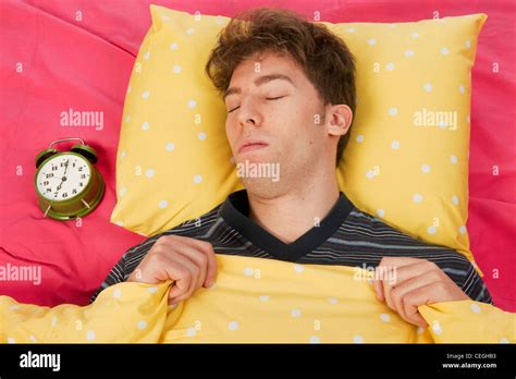 Man Sleeping In Bed With Head On Yellow Pillow Stock Photo Alamy