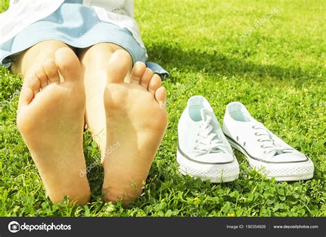 Female Bare Feet On Mawed Lawn Grass Young Woman Resting Outdoors Barefoot Take A Break