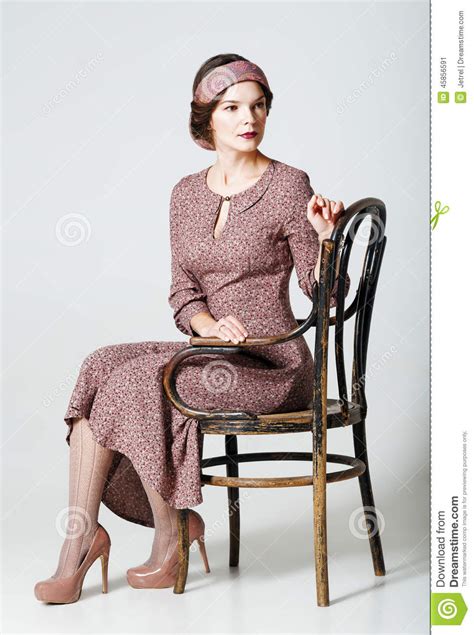 Lovely Young Woman Sitting On Chair Portrait In Retro Style Stock