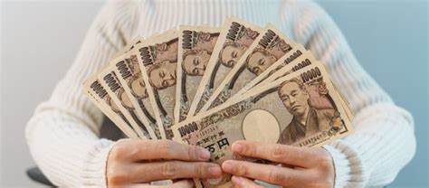 Woman Hand Counting Japanese Yen Banknote Over Table Background