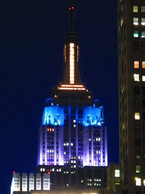 The Empire State Building Lit Up In Purple Blue Yellow In Honor The