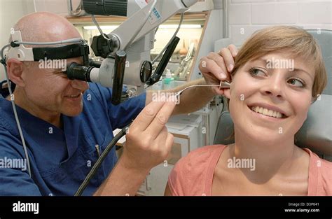 An Otorhinolaryngologist Checks The Ear Of A Patient In His Doctors