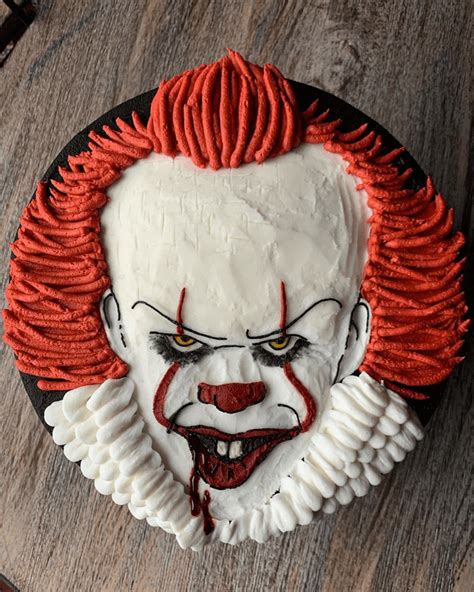 A Close Up Of A Cake On A Table With A Clown Face Painted On It