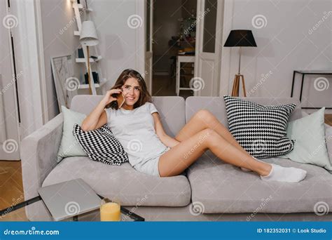 Dreamy Young Woman In Pajamas Lying On Cozy Couch And Talking On Phone Pretty Female Model In