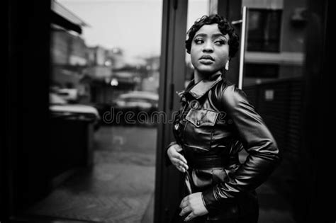 Fashionable Beautiful African American Woman Posing In Black Leather Jacket At Street Stock