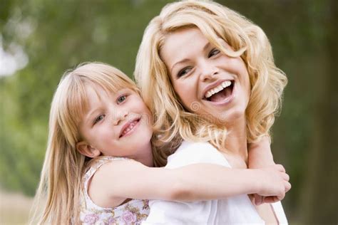 Mother Holding Daughter Outdoors Smiling Stock Image Image Of Laughing Outside 5937023