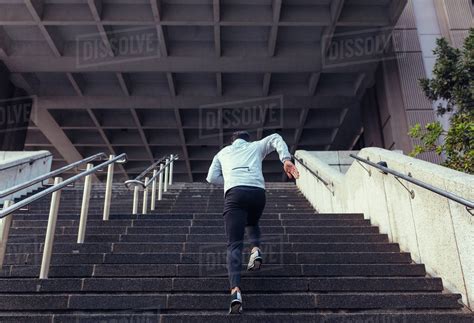 Man Running Up The Stairs Of A Building Athlete Climbing Stairs As