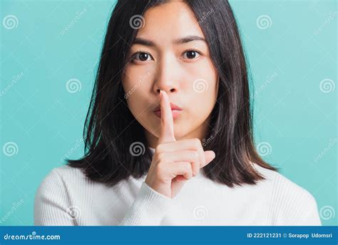 woman holding index finger on her mouth lips stock image image of people asian 222121231