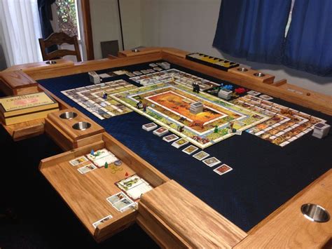 A Board Game Set Up On Top Of A Wooden Table In A Room With Blue Drapes