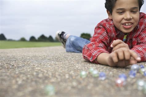 Boy Playing Marbles On Playground Royalty Free Stock Images Image