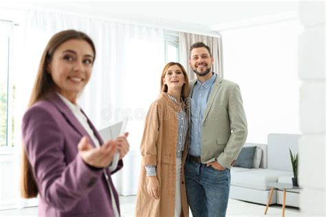 Female Real Estate Agent Showing New House To Couple Stock Image Image Of Agent Apartment