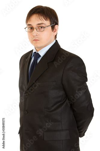 Serious Young Businessman Holding Hands Behind His Back Stock Photo
