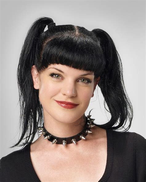 A Woman With Long Black Hair Wearing A Spiked Choker And Necklace On