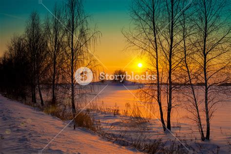 Sunset Over Snowy Field With Trees Royalty Free Stock Image Storyblocks