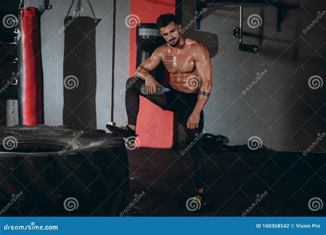 Professional Bodybuilding Man Posing In Front Of The Camera Showing His