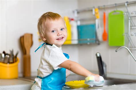 Toddler Child Washing Dishes In Kitchen Little Boy Having Fun With