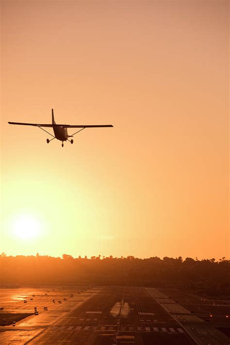 A Plane Landing At Sunset Photograph By Rob Hammer