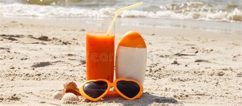 Carrot Juice Sunglasses And Sun Lotion At Beach Concept Of Vitamin A And Beautiful Lasting