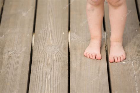 Premium Photo Closeup Of Childs Bare Feet On Wooden Floor Toddlers