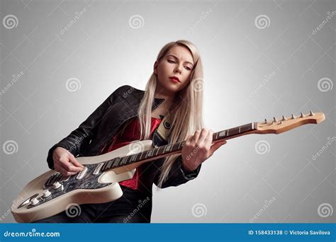 Young Woman Playing Electric Guitar On Grey Background Stock Photo