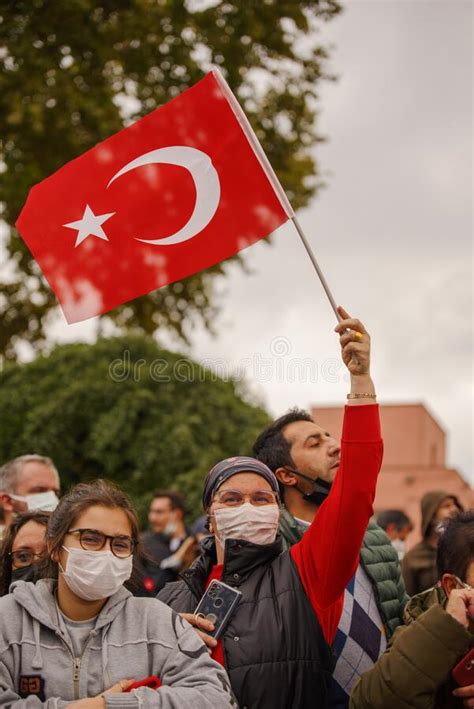 a masked woman holding turkish flags in celebration of republic day 29 october editorial shot