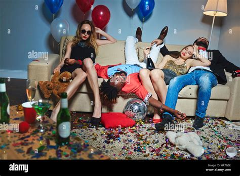 Messy Room After Wild House Party Three Tipsy Stylish Friends Relaxing On Couch While Blond